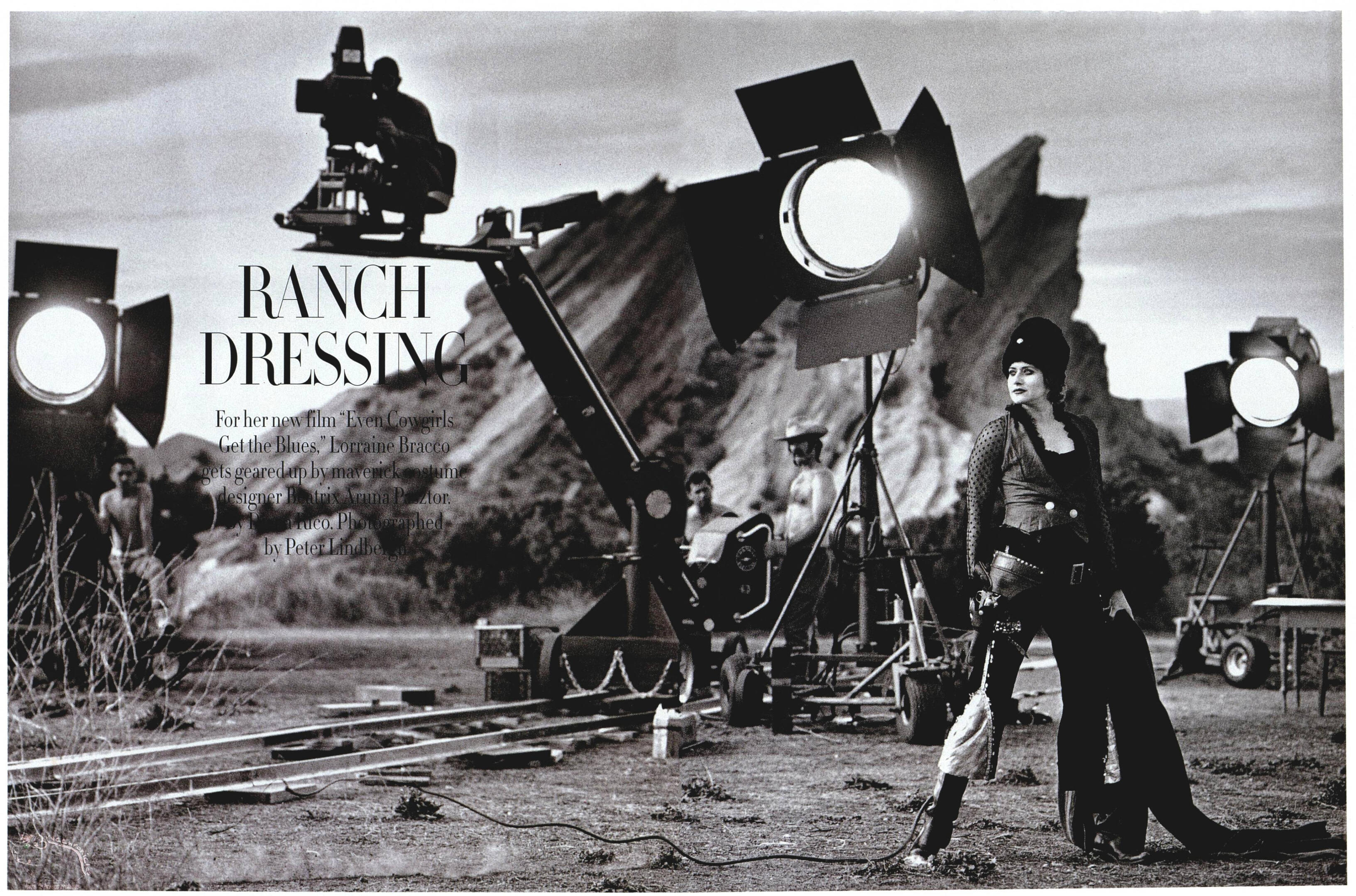 Harper's BAZAAR black-and-white spread "Ranch Dressing" featuring Lorraine Bracco on set for Even Cowgirls Get the Blues. Fashion photography by Peter Lindbergh with movie lights and desert rocks.