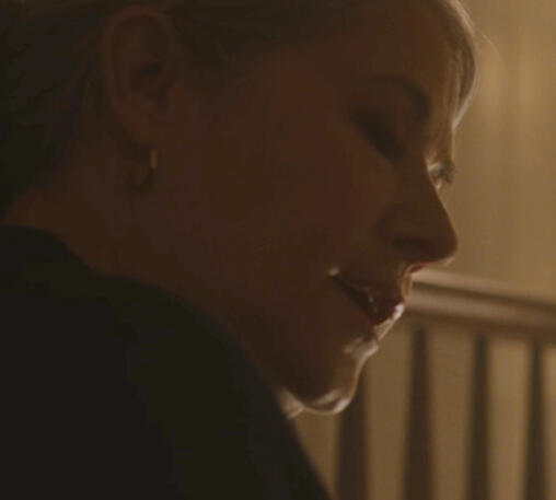 3 Lorraine Bracco close-up looking down in warm indoor lighting in Monster Summer.