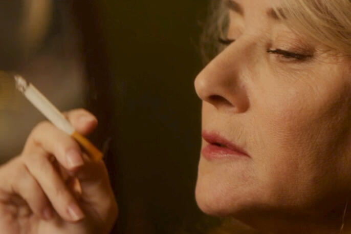 4 Close-up profile of Lorraine Bracco holding a cigarette in Jacir movie.