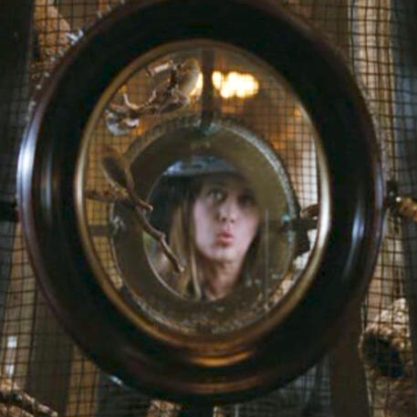 5 Lorraine Bracco pouting looking at her reflection in an ornate oval window in Son of Morning.