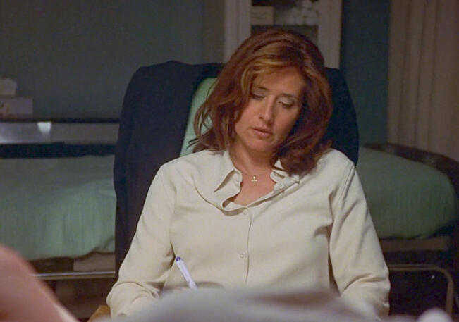 8 Lorraine Bracco sitting in a visitors chair at a hospital, in Tangled.
