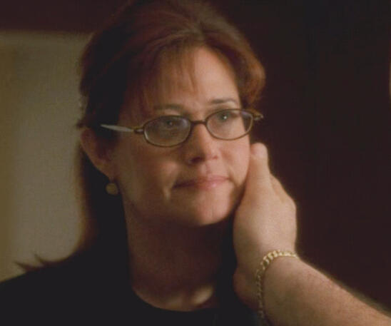10 Tony Soprano gently touching Dr. Melfi's face in a close-up scene from The Sopranos.