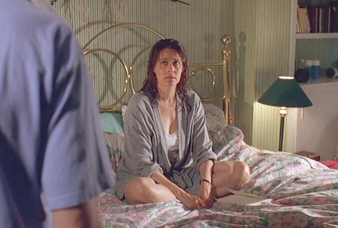 12 Lorraine Bracco with wet hair sitting on a bed looking distraught in Silent Cradle.
