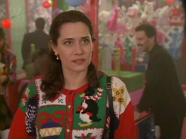 1 Lorraine Bracco wearing a festive Christmas sweater in a scene from the movie Getting Gotti.