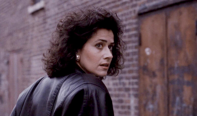 5 Karen Hill played by Lorraine Bracco looking back anxiously on a city street in Goodfellas.