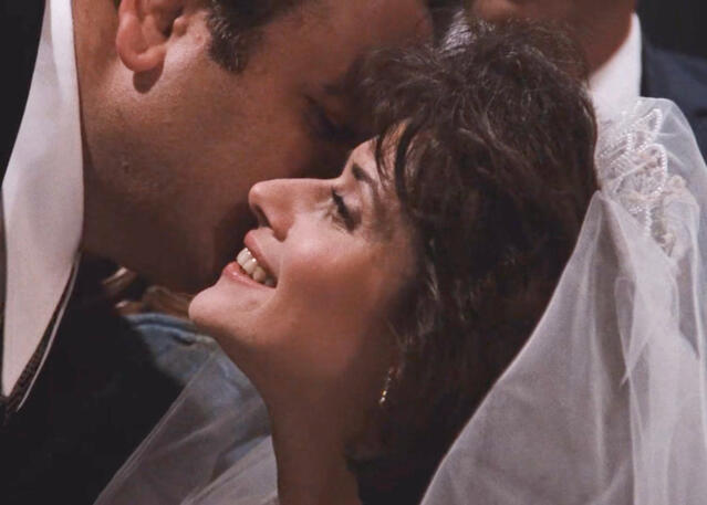 9 Profile close-up of Lorraine Bracco smiling as Karen Hill on her wedding day in the movie Goodfellas.