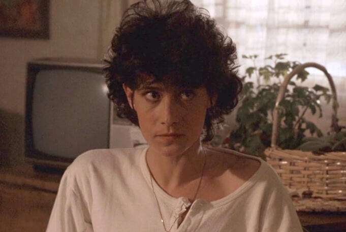 9 Lorraine Bracco in a white shirt looking up in Someone to Watch Over Me.
