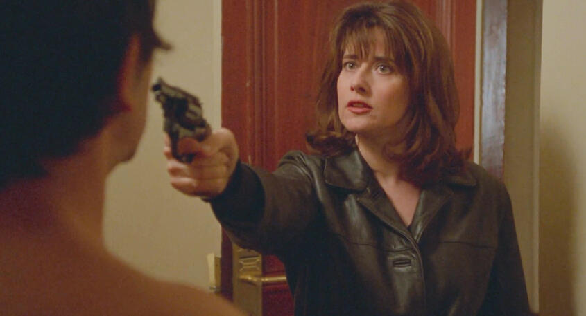 10 Lorraine Bracco pointing a pistol gun at Jean-Hugues Anglade in Les Menteurs